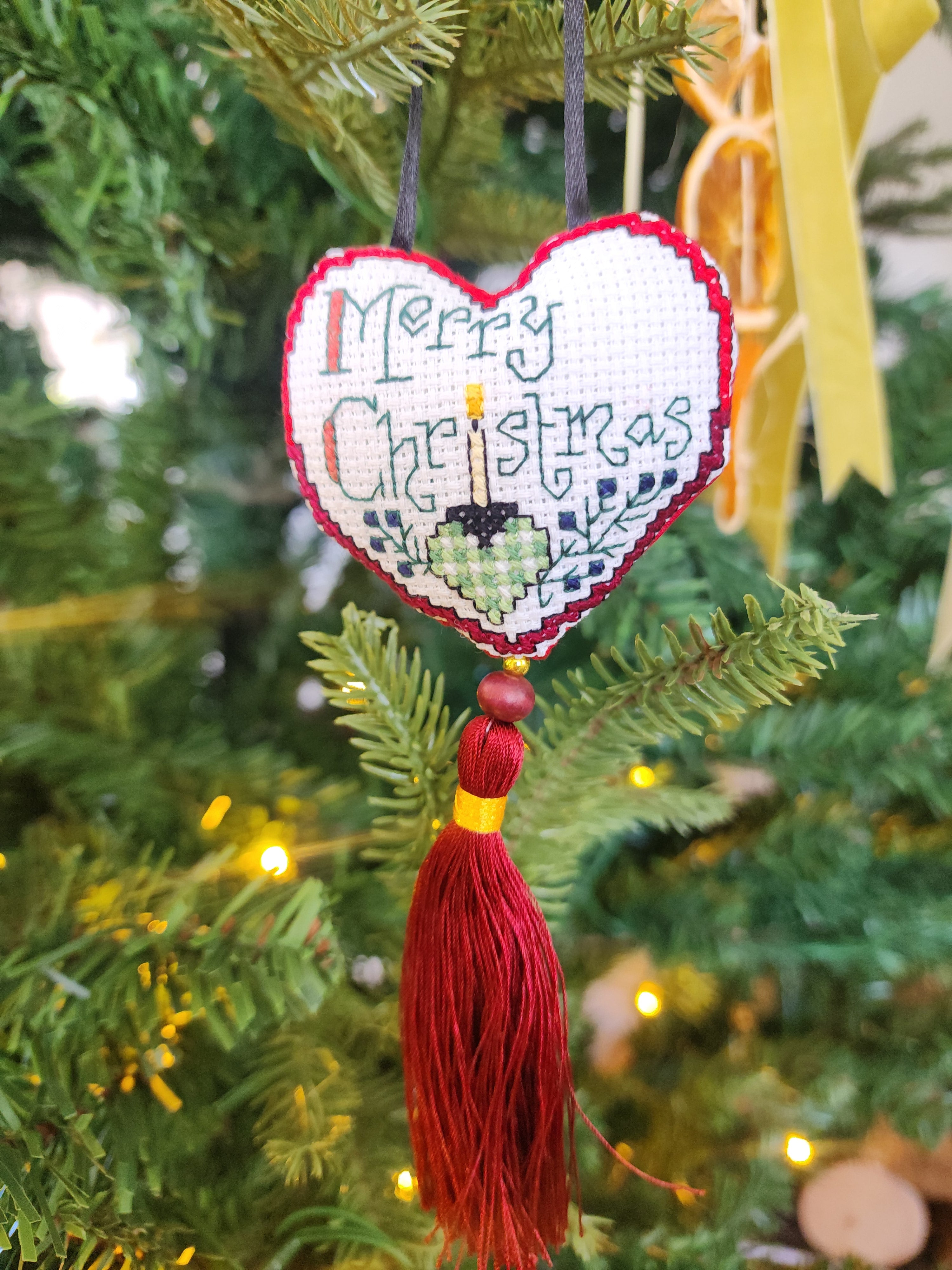 Hand stitched heart ornament with red tassle
