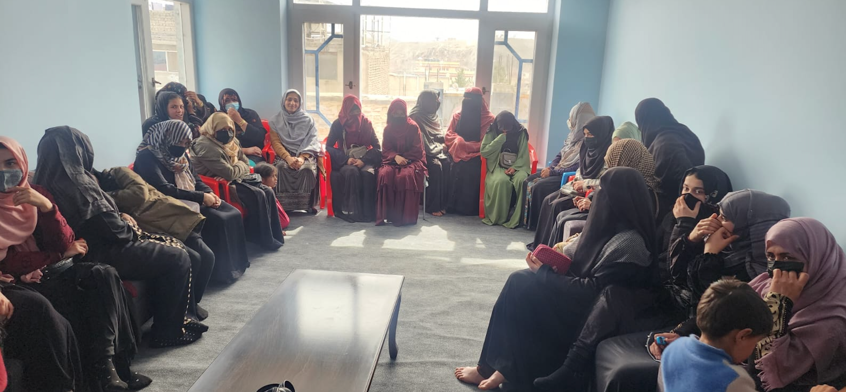 Afghan women line up in the hope of a job.