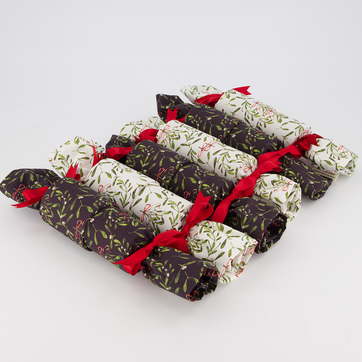 Mistletoe reusable Christmas crackers, 6 unboxed in a row