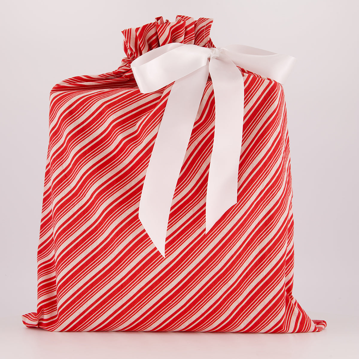 Large reusable gift bag — bold candy cane stripe in red and white — handmade in Afghanistan