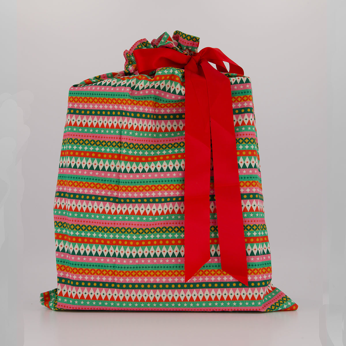 Large reusable gift bag — vibrant fiesta print in red, pink, green and gold — handmade in Afghanistan