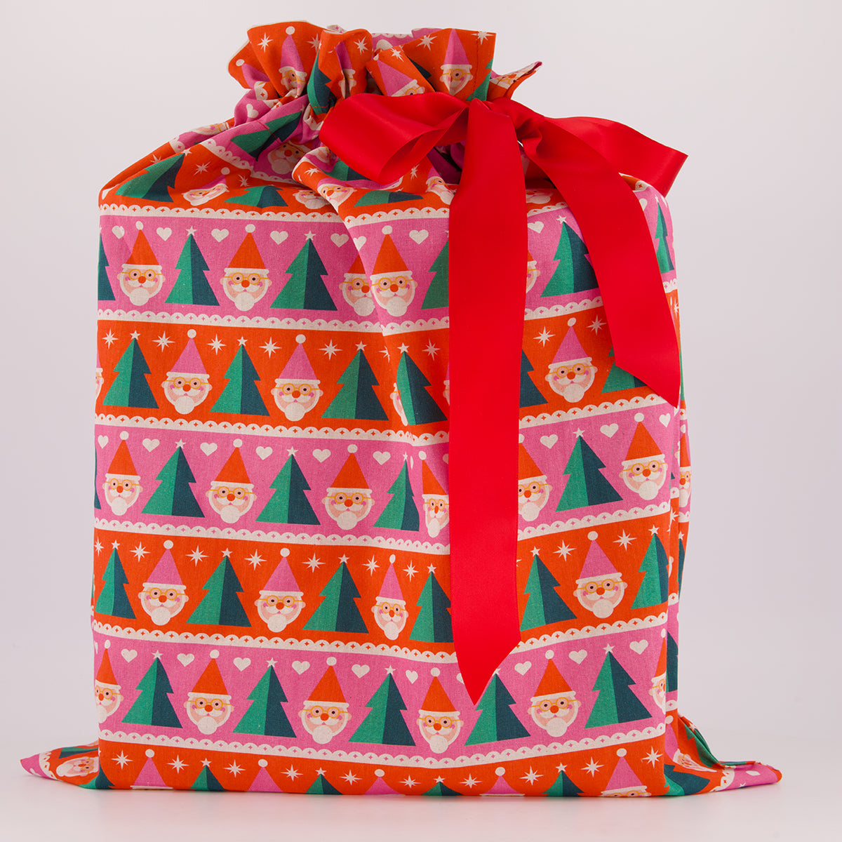 Large reusable gift bag — playful Papa Noel print in pink, red and green — handmade in Afghanistan