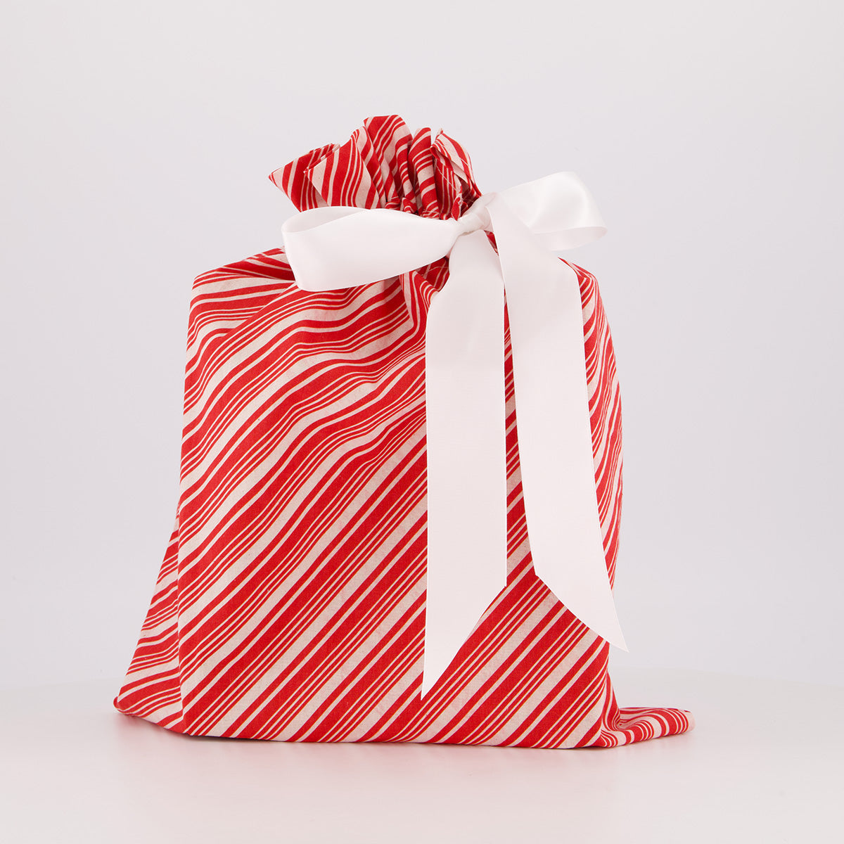 Medium reusable gift bag — bold candy cane stripe in red and white — handmade in Afghanistan