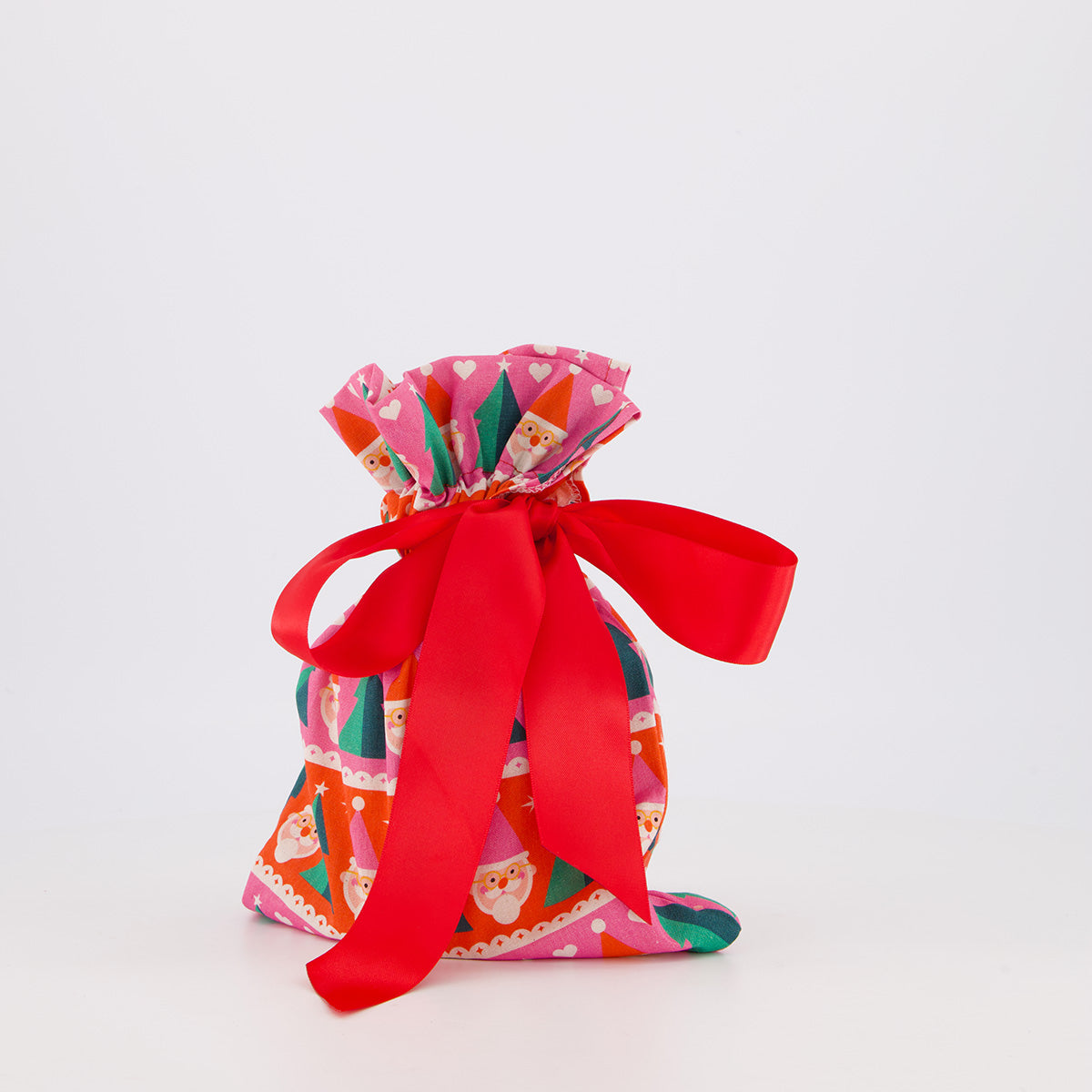 Small reusable gift bag — playful Papa Noel print in pink, red and green — handmade in Afghanistan