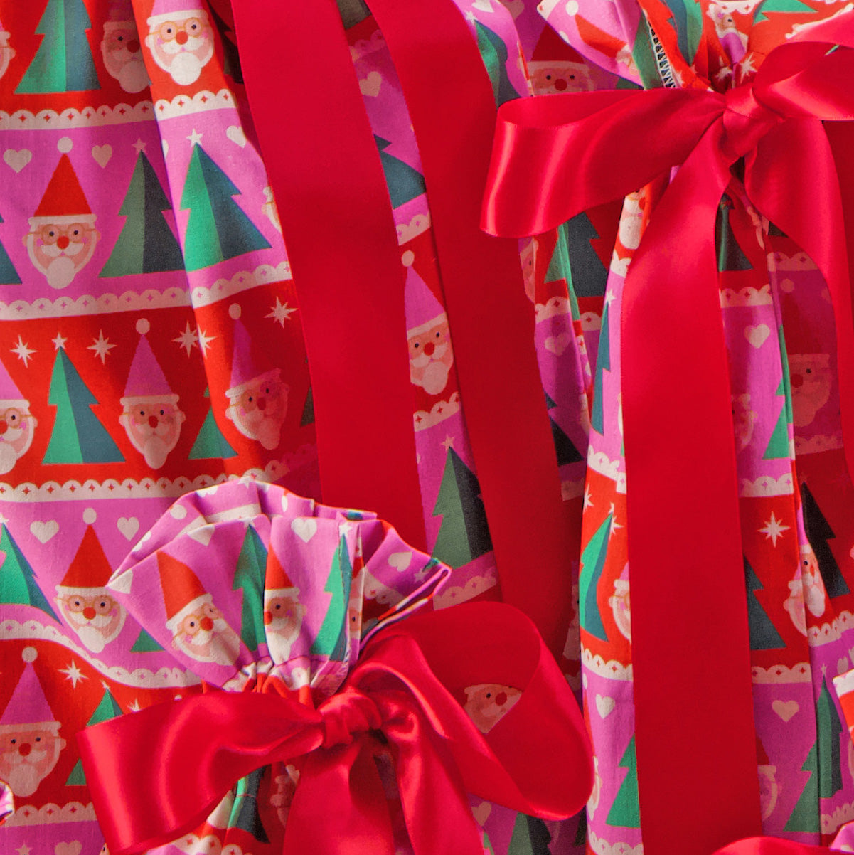 Papa Noel fabric close-up — Santa and Christmas tree print in bold pink, red and green