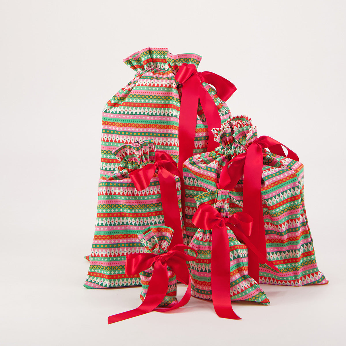 Fiesta reusable gift bag set of 5 — bold geometric stripe print in red, pink, green and gold — handmade in Afghanistan