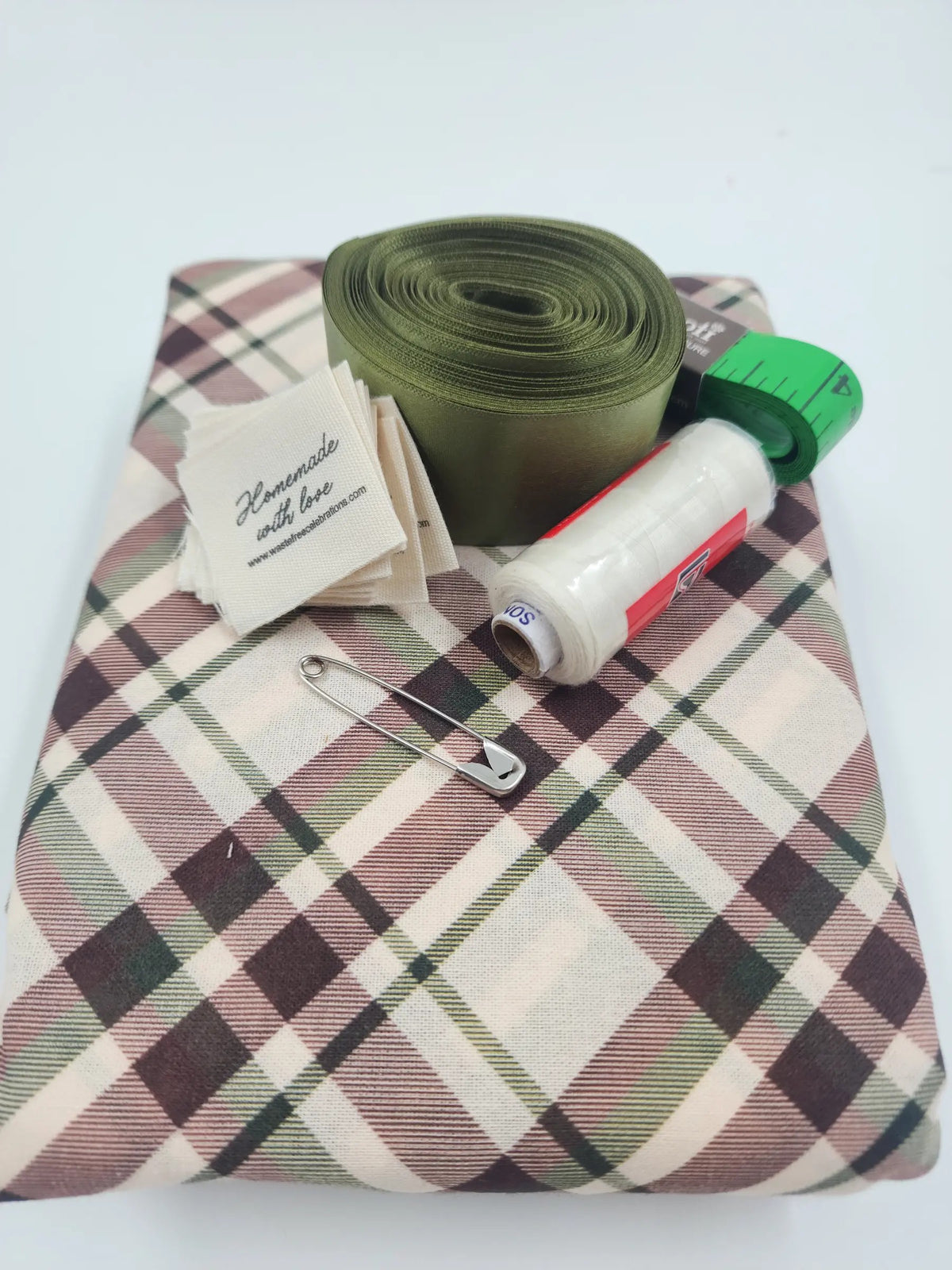 Tartan Sew Your Own reusable gift bag kit — pre-cut tartan fabric in brown, cream and green with olive ribbon, thread, tape measure, safety pin and 'Homemade with love' labels