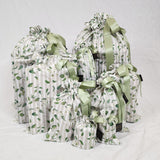 A photo showing a sewn up set of  Sew Your Own gift Bag set in Australiana Watercolour. The fabric has taupe and cream stripes with a green leaf print.