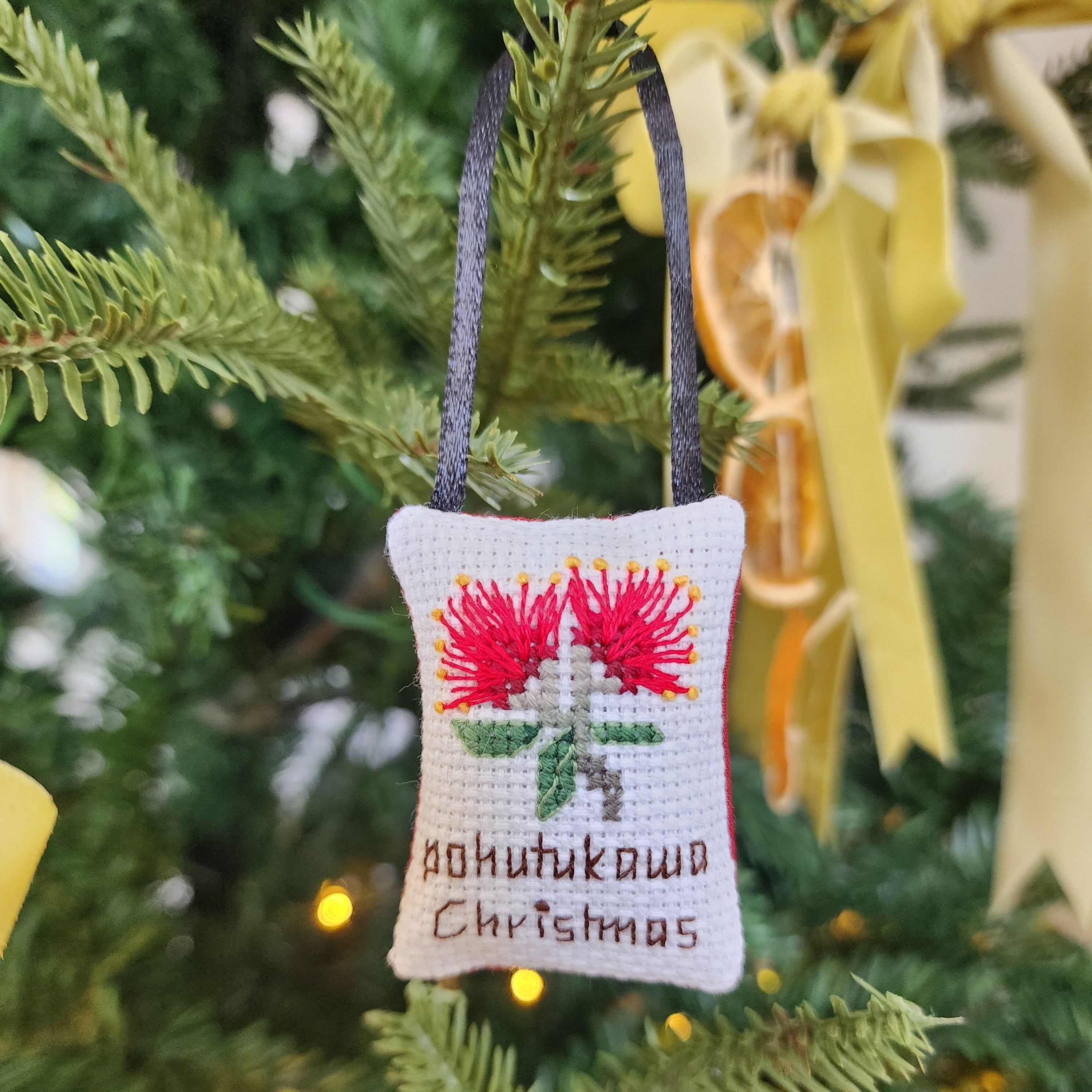 Decorative Christmas ornament with Pohutukawa Christmas' text on a white background
