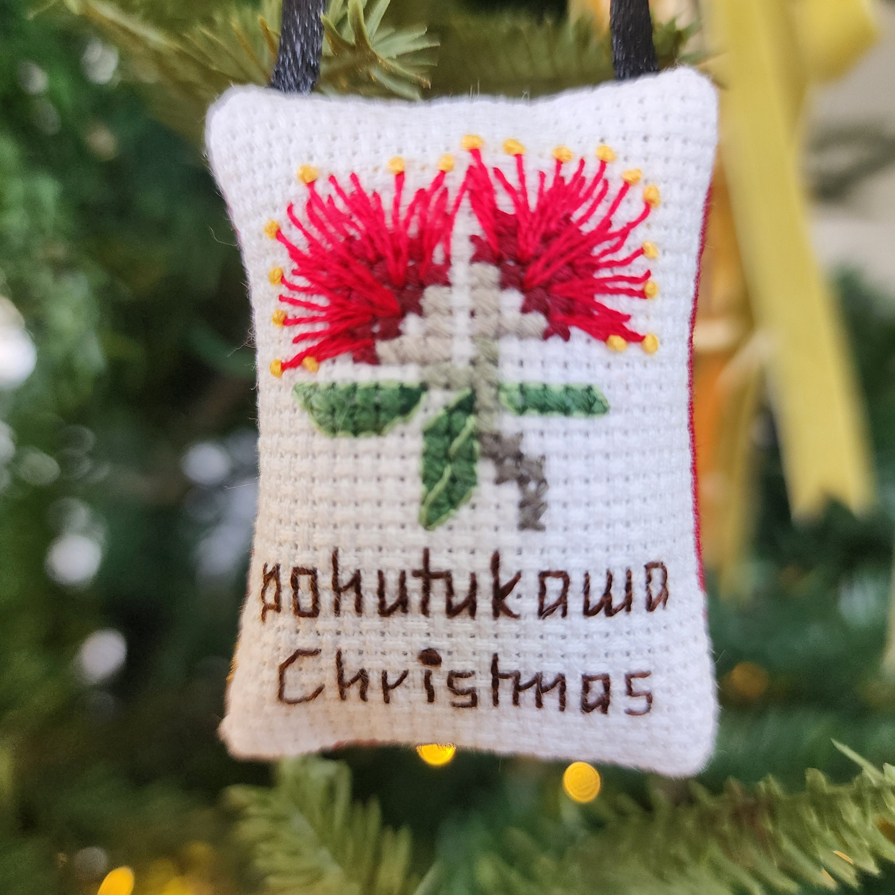 Decorative Christmas ornament with Pohutukawa Christmas' text on a white background