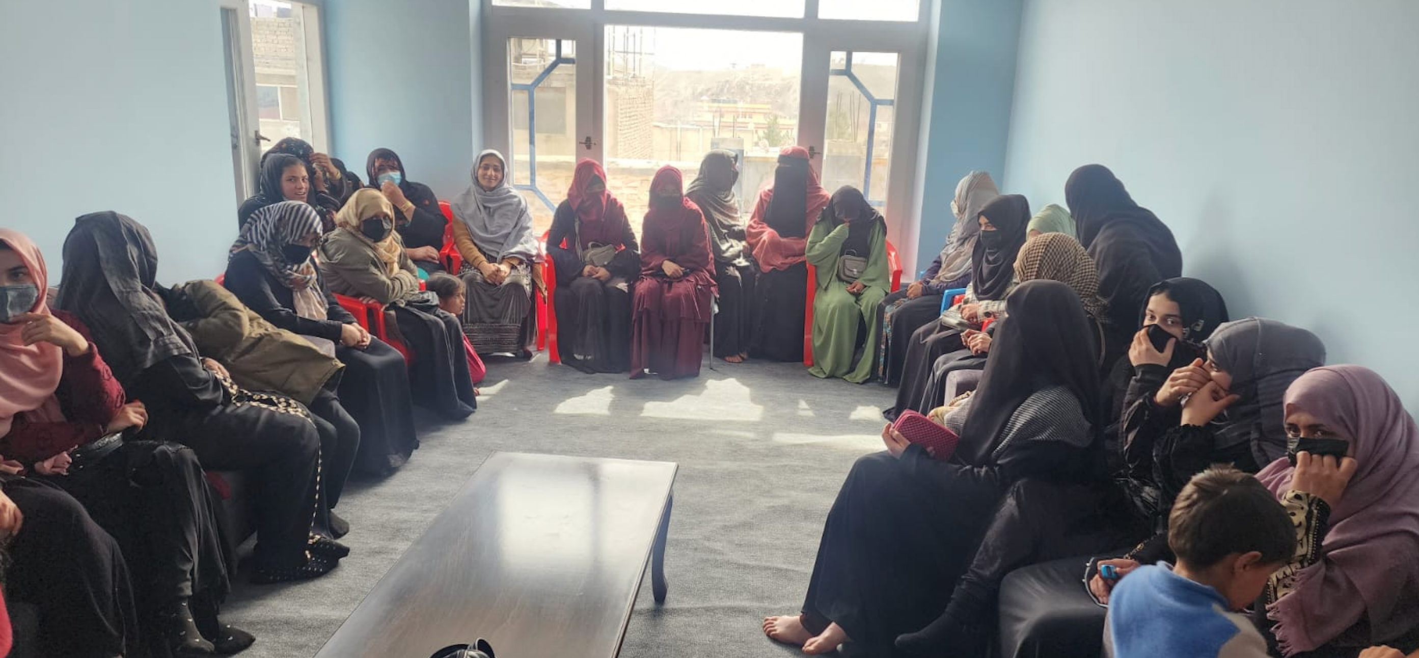 Afghan women line up in the hope of a job. 