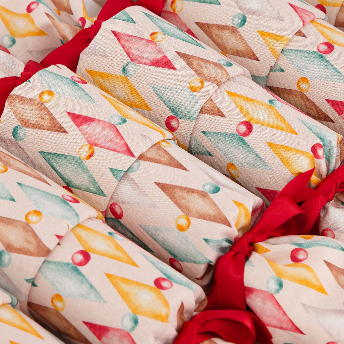 Harlekin reusable Christmas cracker — close-up of coral red pohutakawa bloom fabric detail