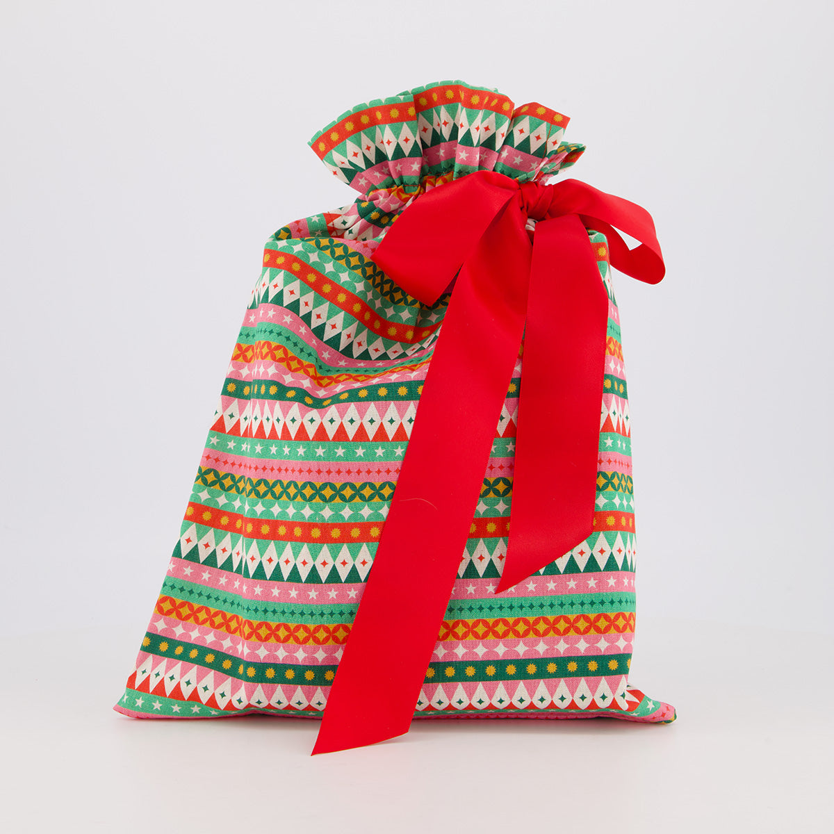 Book reusable gift bag — vibrant fiesta print in red, pink, green and gold — handmade in Afghanistan