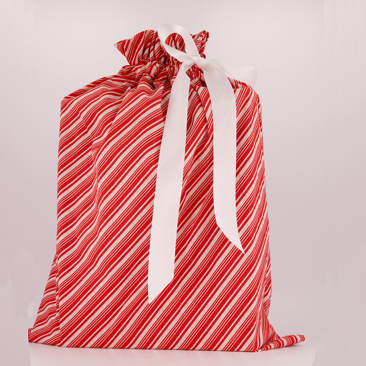 Santa Sack reusable gift bag — bold candy cane stripe in red and white — handmade in Afghanistan