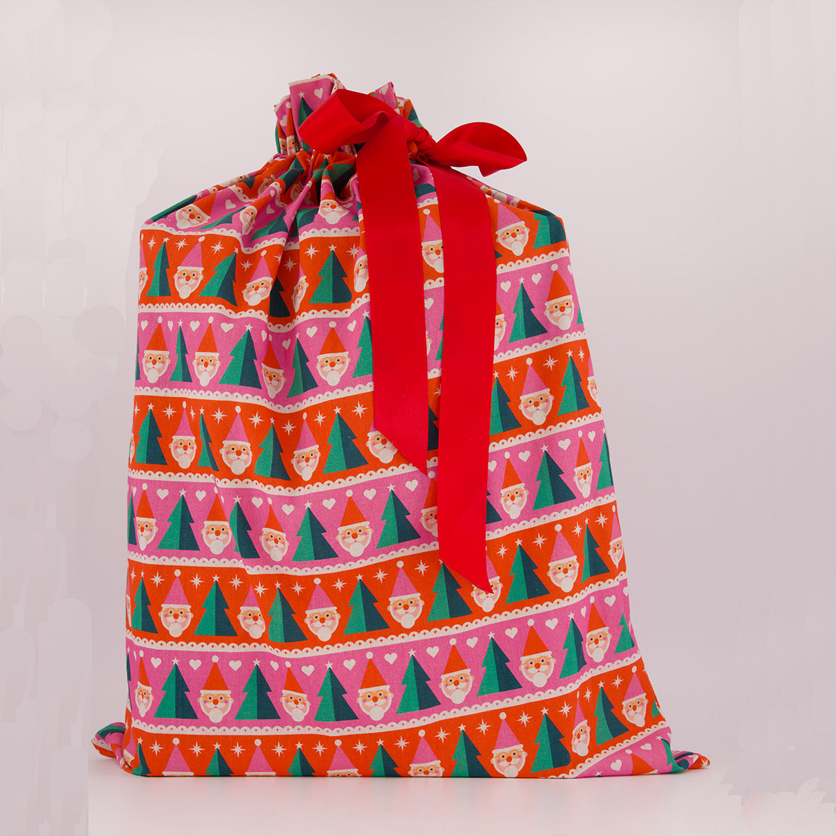 Santa Sack reusable gift bag — playful Papa Noel print in pink, red and green — handmade in Afghanistan