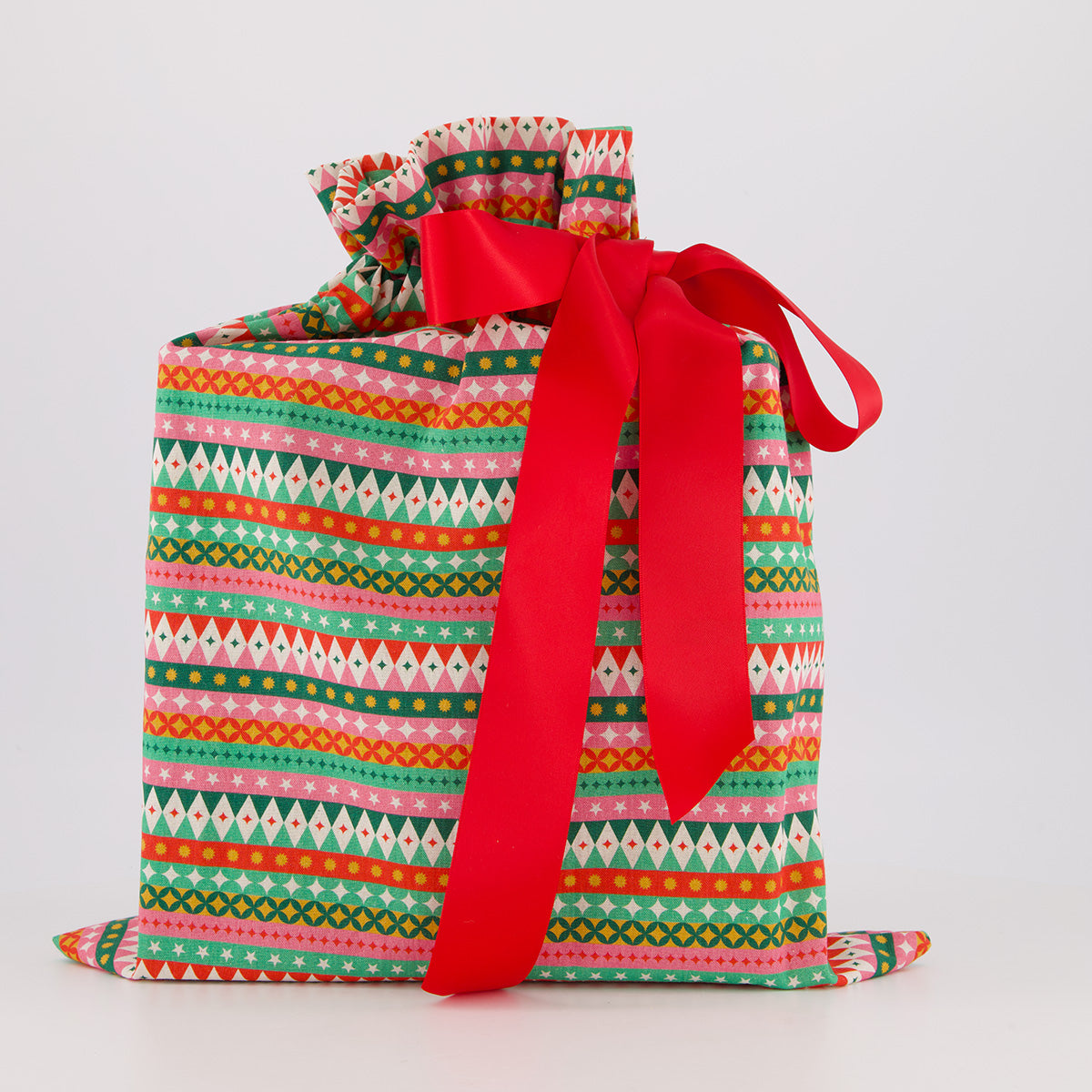 Medium reusable gift bag — vibrant fiesta print in red, pink, green and gold — handmade in Afghanistan