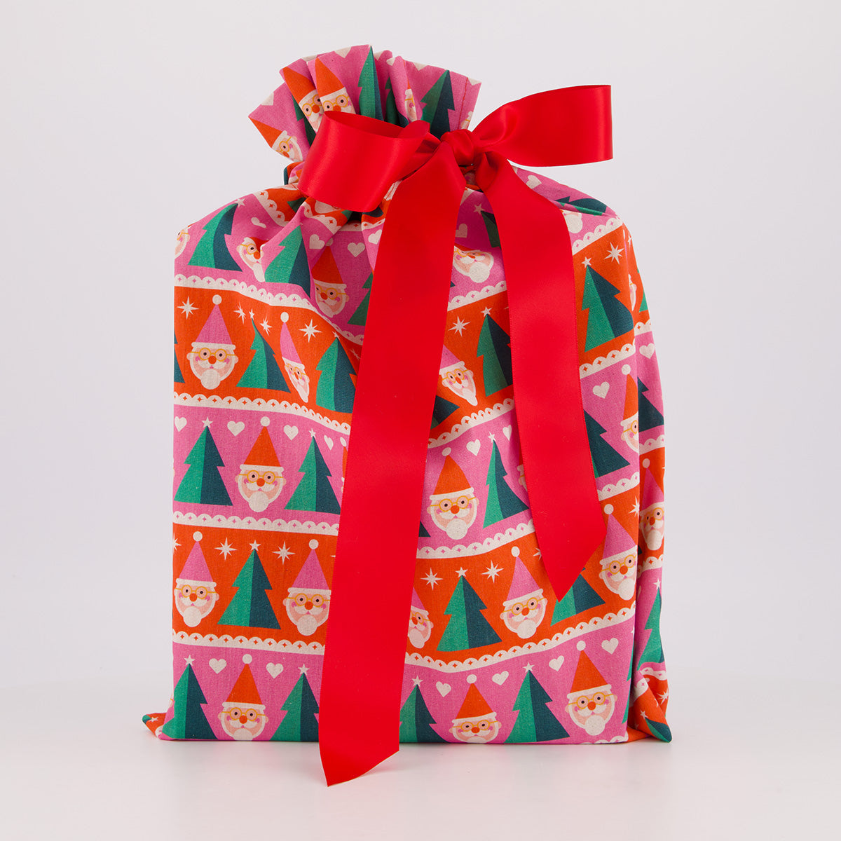 Medium reusable gift bag — playful Papa Noel print in pink, red and green — handmade in Afghanistan