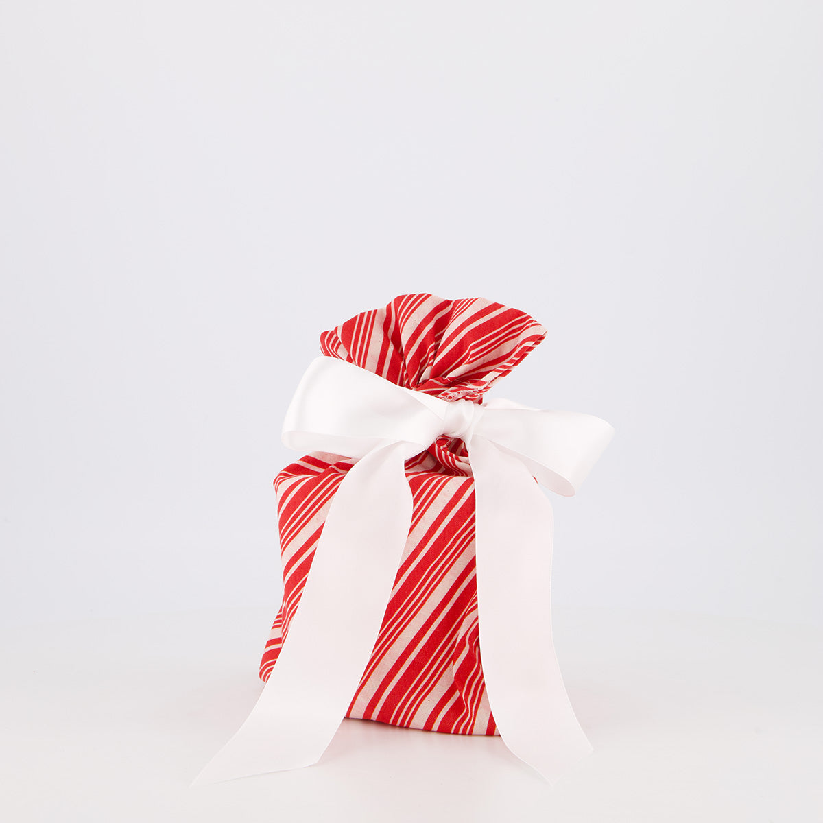 Small reusable gift bag — bold candy cane stripe in red and white — handmade in Afghanistan