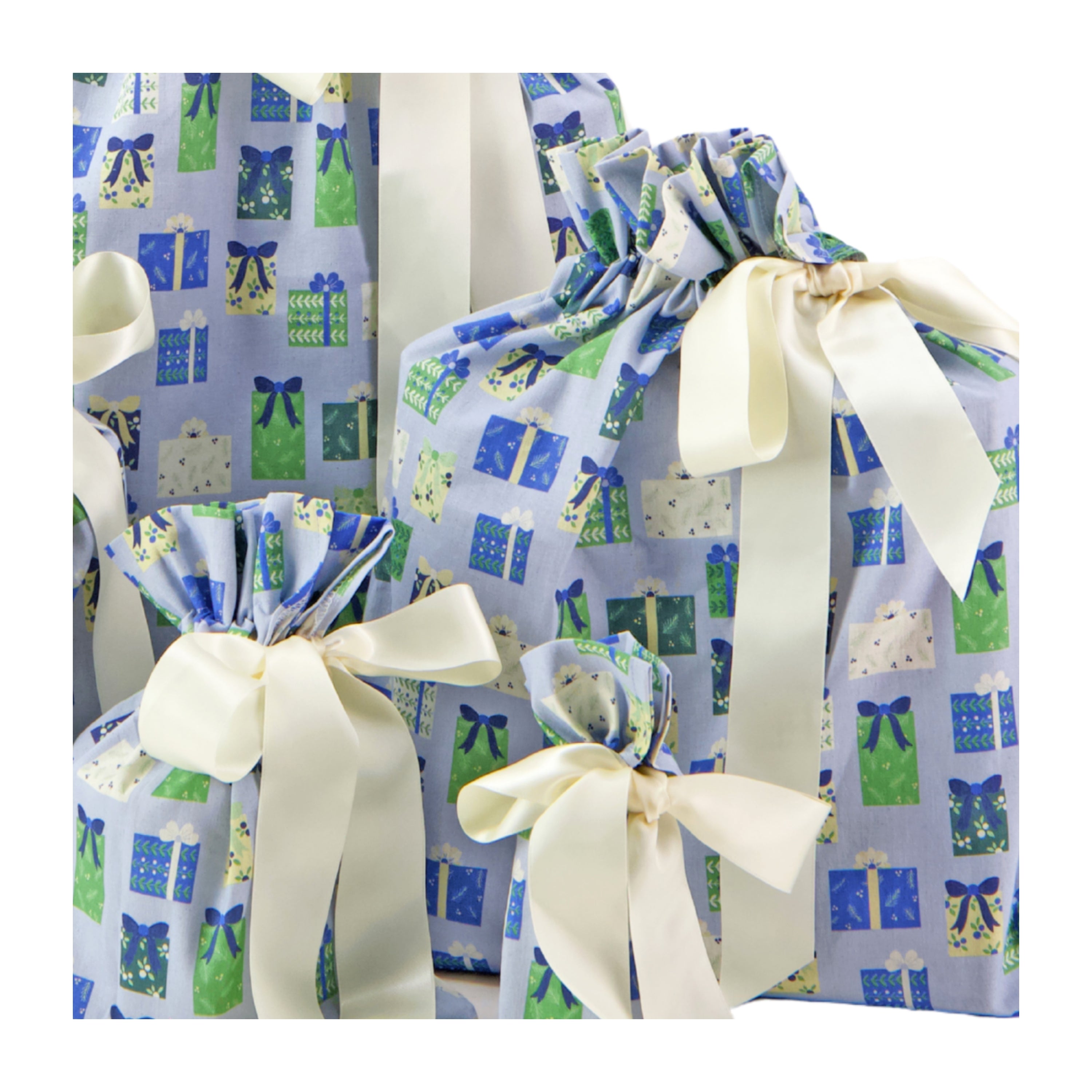 Folk Gaver fabric close-up — illustrated gift box print in soft blue, sage and cream