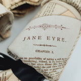Close up of a Beethoven and Bronte Re-Cracker (reusable Christmas Crackers or Bon bons). Image shows a cracker with a piece of writing from Jane Eyre and a black satin ribbon.