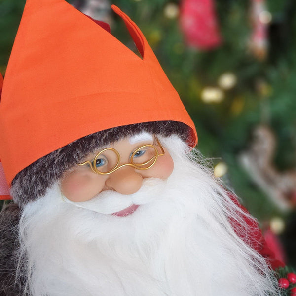 Santa wearing an orange reusable cotton crown.